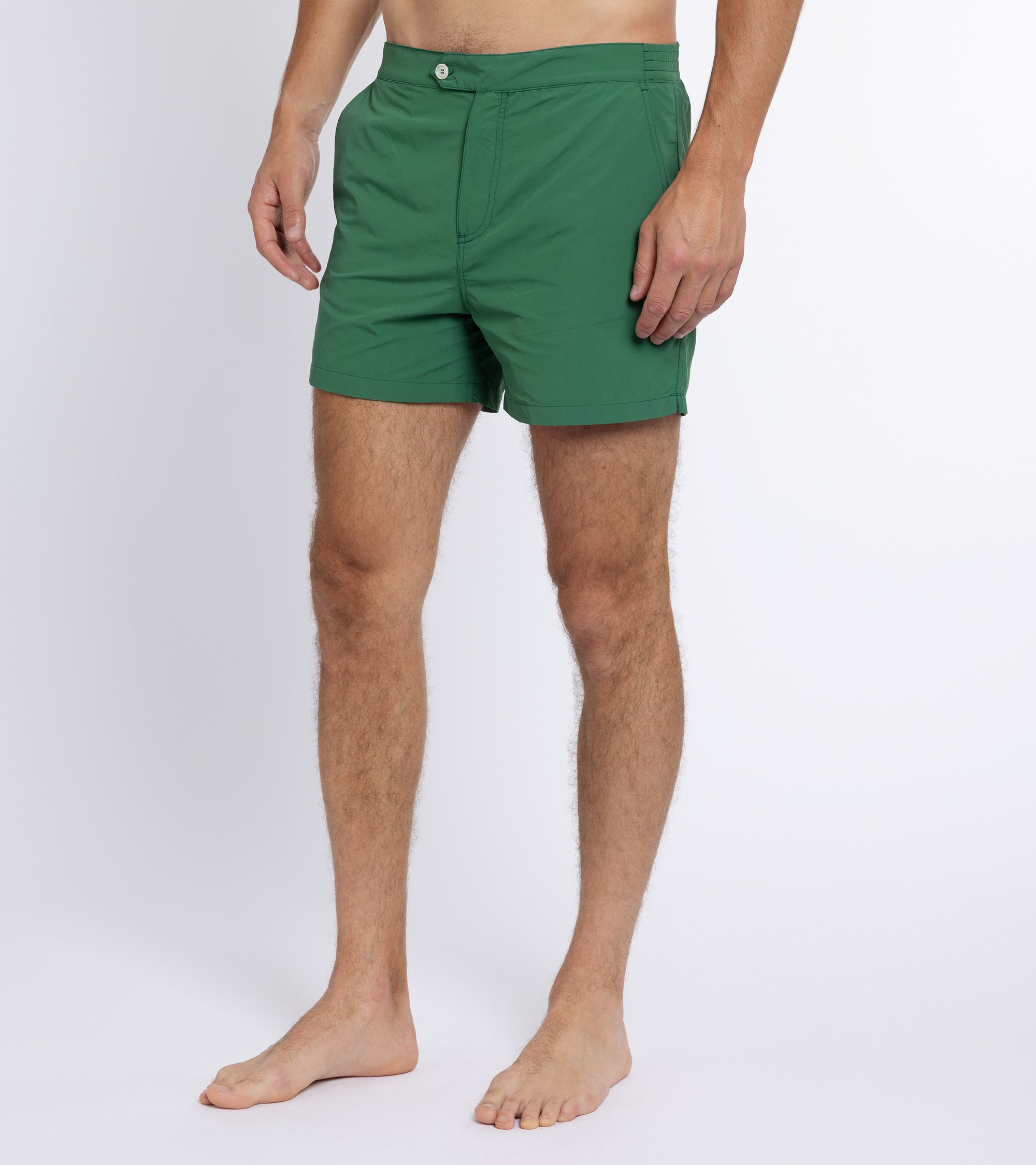 Trunk Foley swim shorts in green, styled shot.
