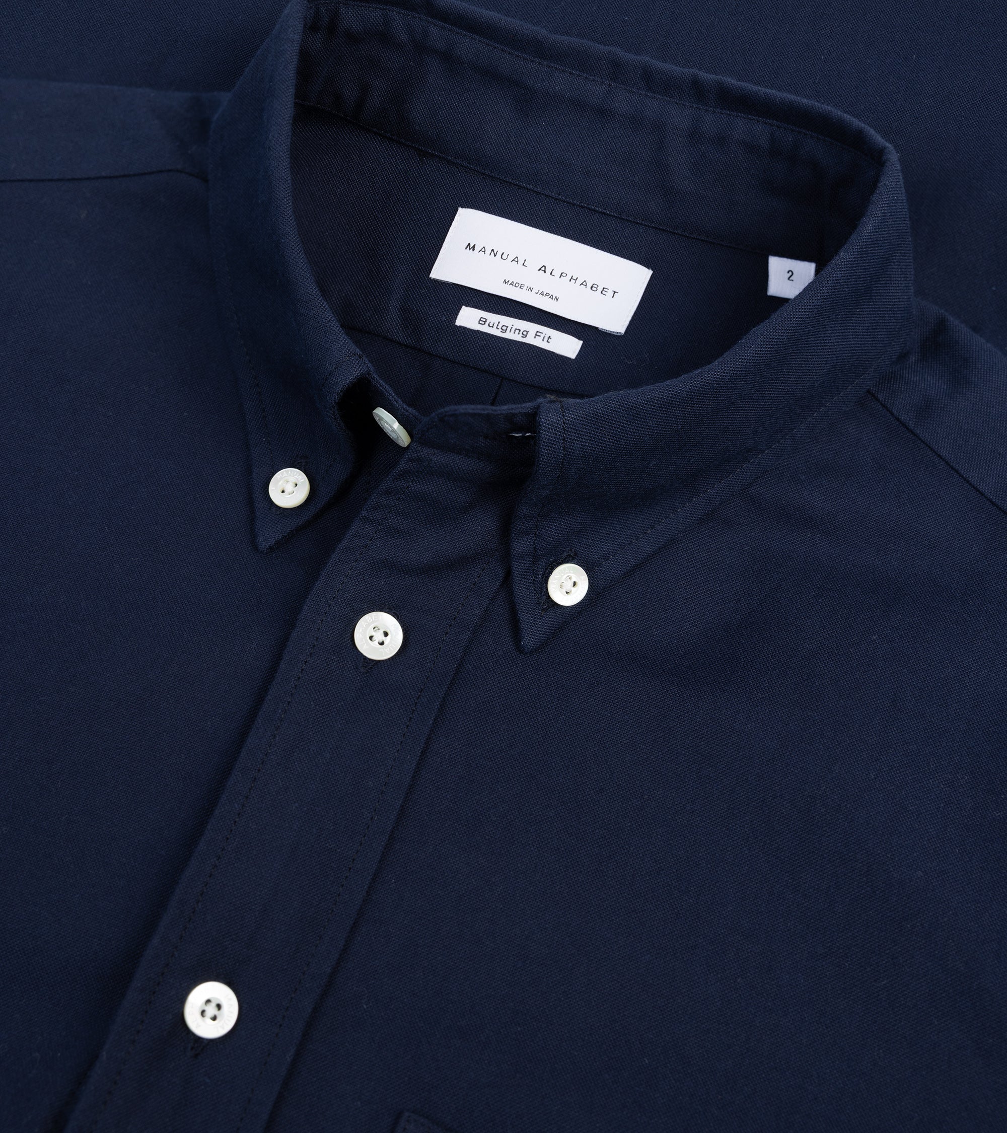 Manual Alphabet button-down shirt in dark navy Supima cotton Oxford, fabric detail of the Oxford weave.