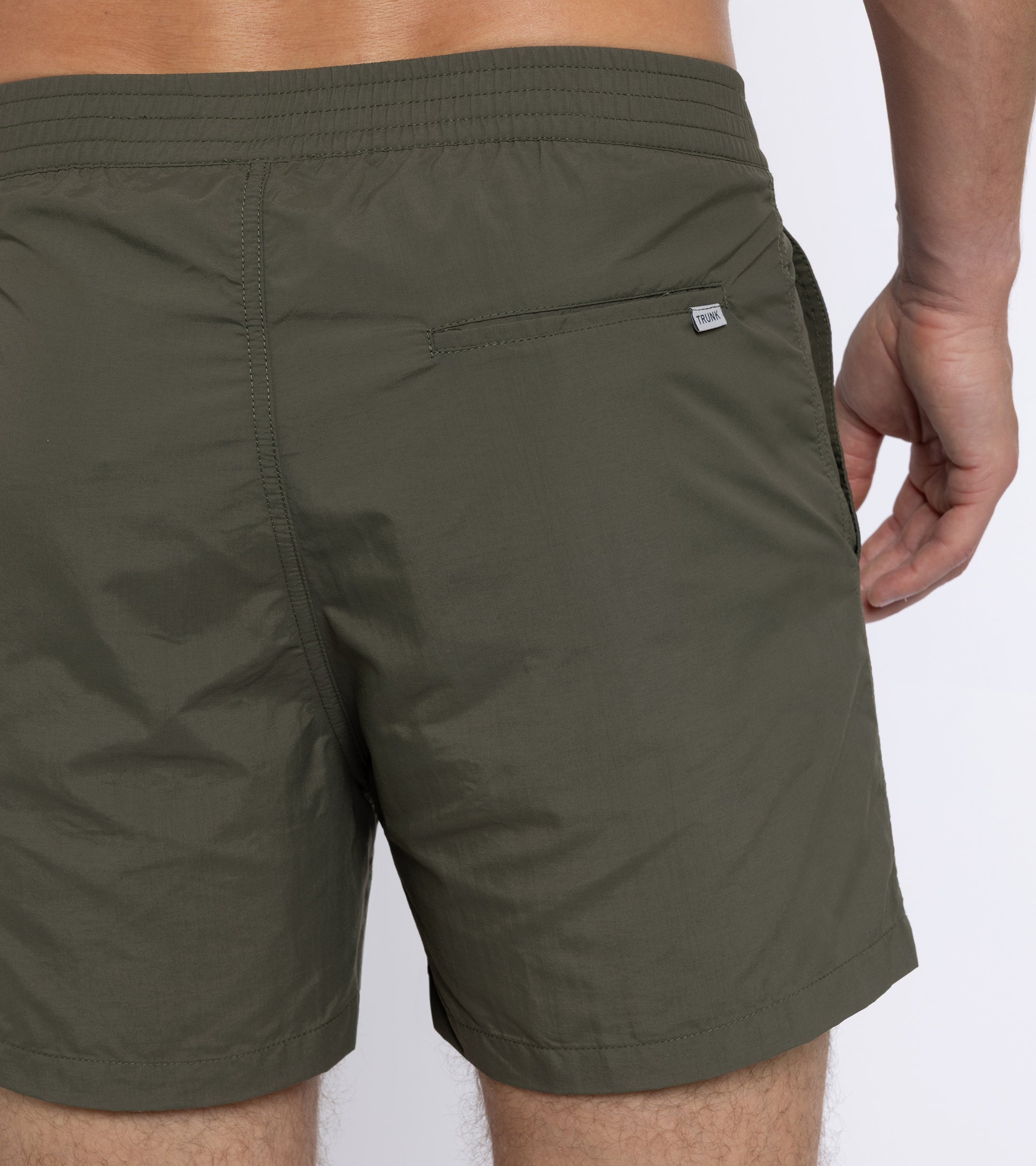 Trunk Foley swim shorts in olive, styled shot.