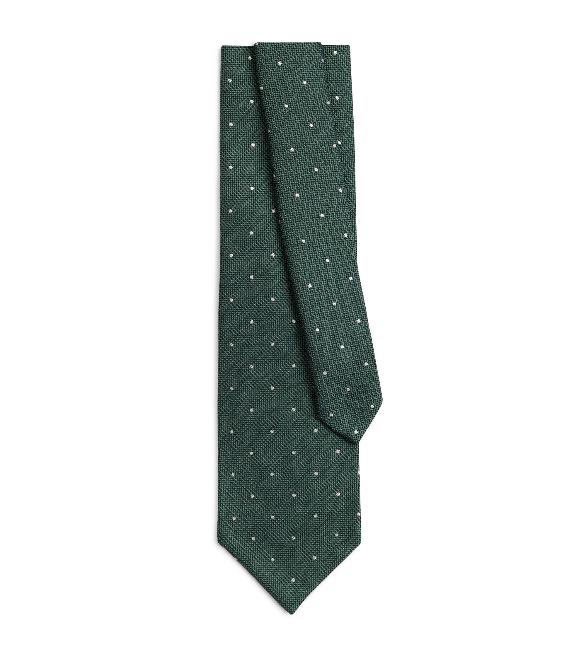A sage green necktie with a small white polka dot pattern, neatly folded and displayed against a solid white background.