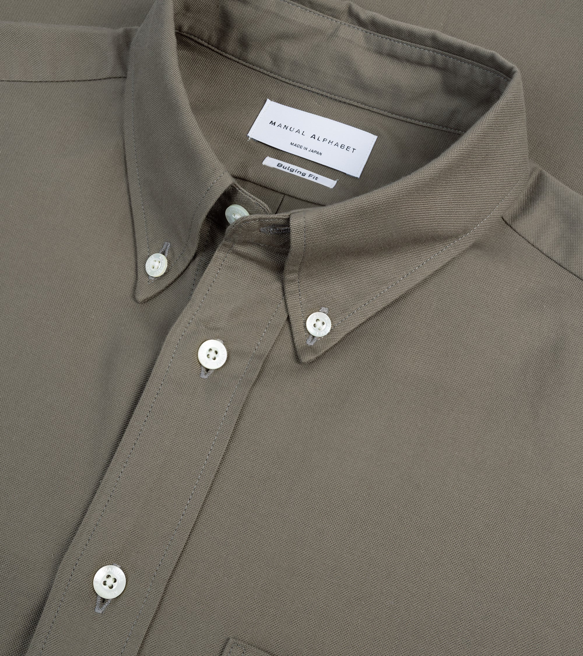 Manual Alphabet button-down shirt in olive Supima cotton Oxford, fabric detail of the Oxford weave.
